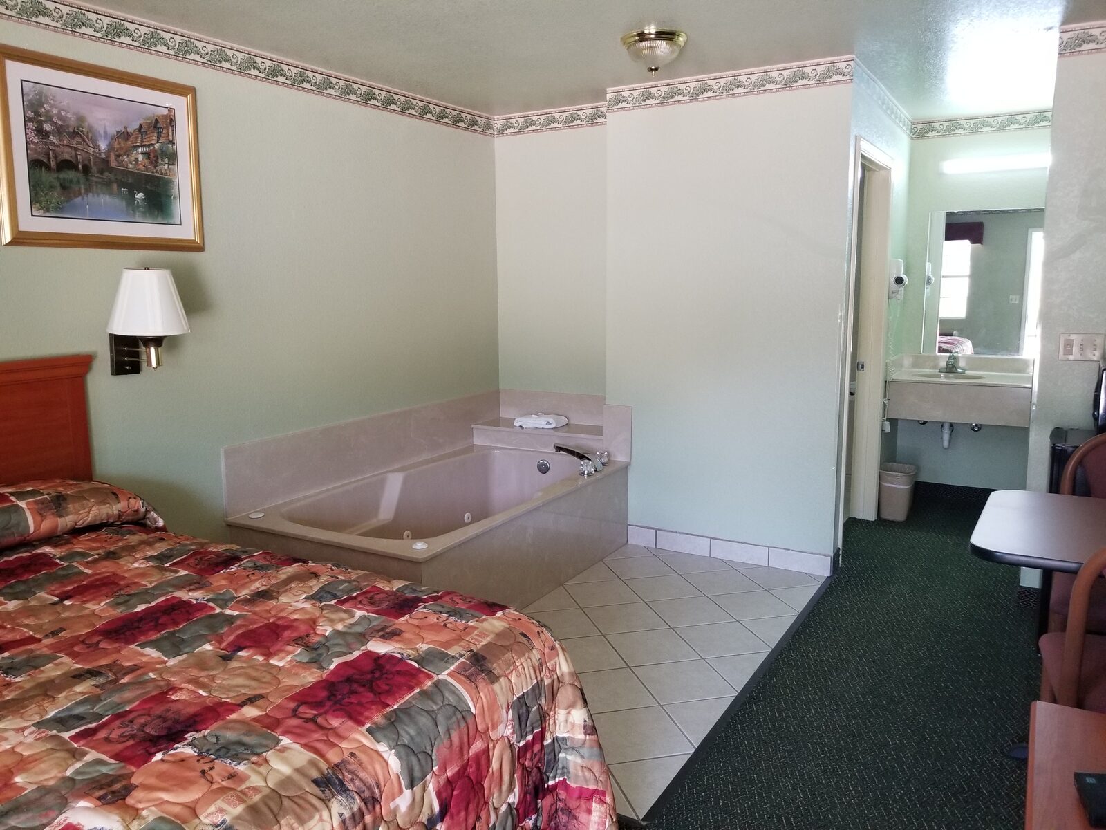 Jacuzzi Suite at Haltom Inn showing king bed and in-room jetted tub — Haltom City Texas