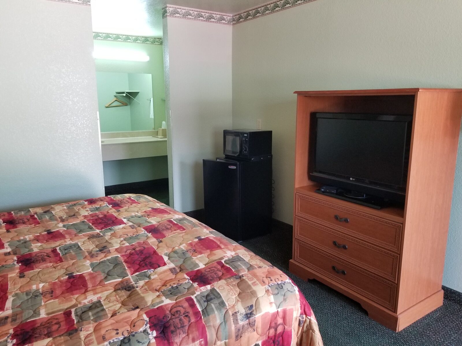 Deluxe King Room at Haltom Inn — comfortable king bed with free WiFi, microwave, and refrigerator